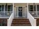 Welcoming front entrance with stairs and decorative flower wreath on the door at 907 Stuart Dr, Mebane, NC 27302