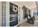 Charming front porch with rocking chairs and floral wreath on the front door at 907 Stuart Dr, Mebane, NC 27302