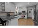 Modern kitchen features granite countertops, stainless steel appliances and white cabinetry at 907 Stuart Dr, Mebane, NC 27302