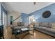 Inviting living room with gray couches, blue accent wall, and view of the staircase at 907 Stuart Dr, Mebane, NC 27302