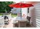 Outdoor dining area with umbrella and backyard views at 907 Stuart Dr, Mebane, NC 27302
