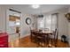 Charming dining room adjacent to the kitchen, showcasing a wood table, hardwood floors and pendant lighting at 9964 N Chestnut St, Middlesex, NC 27557