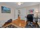 Functional office space with hardwood floors, a desk, artwork and natural light at 9964 N Chestnut St, Middlesex, NC 27557
