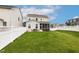 Spacious backyard with lush lawn, patio area, and white fence, perfect for outdoor activities and relaxation at 100 Emory Bluffs Dr, Holly Springs, NC 27540