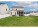 Expansive backyard with lush lawn, patio area, and white privacy fence, great for entertainment and relaxing at 100 Emory Bluffs Dr, Holly Springs, NC 27540