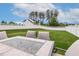 Picturesque backyard with lush green grass, privacy fence, and an outdoor dining area ready for entertaining at 100 Emory Bluffs Dr, Holly Springs, NC 27540
