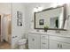Elegant bathroom with double sink vanity, a large mirror, and a bathtub at 100 Emory Bluffs Dr, Holly Springs, NC 27540