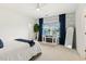 Cozy bedroom with white walls, a decorative fireplace, and large windows with curtains at 100 Emory Bluffs Dr, Holly Springs, NC 27540