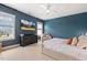 Bedroom features a modern ceiling fan, an upholstered bed, and a TV at 100 Emory Bluffs Dr, Holly Springs, NC 27540