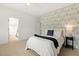 Bedroom with patterned accent wall, ensuite bath, and walk-in closet at 100 Emory Bluffs Dr, Holly Springs, NC 27540