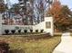 Well-maintained community entrance with brick signage and landscaping, creating a welcoming arrival at 100 Emory Bluffs Dr, Holly Springs, NC 27540