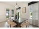 Bright dining room featuring modern chandelier, table, chairs, and natural light at 100 Emory Bluffs Dr, Holly Springs, NC 27540