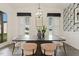 Dining room showcasing a modern chandelier, stylish table, chairs, and decorative wallpaper at 100 Emory Bluffs Dr, Holly Springs, NC 27540
