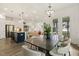 Dining area with modern chandelier, stylish dining table, chairs, and an open concept layout at 100 Emory Bluffs Dr, Holly Springs, NC 27540