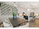 Dining area featuring modern chandelier, dining table, chairs, and an open concept layout at 100 Emory Bluffs Dr, Holly Springs, NC 27540