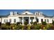 Bright, white house featuring a column-lined porch, black shutters, and a well-manicured lawn at 100 Emory Bluffs Dr, Holly Springs, NC 27540