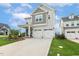 Charming two-story home with a two-car garage, covered porch, and landscaped front yard at 100 Emory Bluffs Dr, Holly Springs, NC 27540