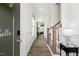 Bright foyer with hardwood floors, wainscoting, and a staircase leading to the upper level at 100 Emory Bluffs Dr, Holly Springs, NC 27540