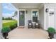 Inviting front porch with rocking chairs, a welcome wreath, and lovely potted plants at 100 Emory Bluffs Dr, Holly Springs, NC 27540