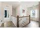 Hallway boasts hardwood floors and natural light from a large window at 100 Emory Bluffs Dr, Holly Springs, NC 27540