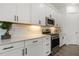 Bright white kitchen with stainless steel appliances, subway tile backsplash, and modern fixtures at 100 Emory Bluffs Dr, Holly Springs, NC 27540