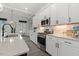 Kitchen with stainless steel appliances, white cabinets and quartz countertops at 100 Emory Bluffs Dr, Holly Springs, NC 27540
