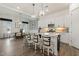 Spacious kitchen with island and seating, open to the dining area and living room at 100 Emory Bluffs Dr, Holly Springs, NC 27540