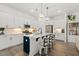Modern kitchen with white cabinets, stainless steel appliances, and large center island at 100 Emory Bluffs Dr, Holly Springs, NC 27540