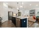 Open concept kitchen featuring a center island, stainless steel appliances, and modern finishes at 100 Emory Bluffs Dr, Holly Springs, NC 27540