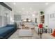 Bright and airy living room leading into the kitchen with stylish furnishings at 100 Emory Bluffs Dr, Holly Springs, NC 27540