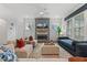 Bright living room with modern fireplace, white walls, and comfortable seating arrangement at 100 Emory Bluffs Dr, Holly Springs, NC 27540