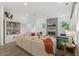 Open living area with a fireplace, large sectional sofa, and modern furnishings at 100 Emory Bluffs Dr, Holly Springs, NC 27540