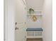 Mudroom with blue cushioned bench, hooks, and shelving near a white door at 100 Emory Bluffs Dr, Holly Springs, NC 27540