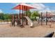 Community playground with shade and various play structures for children at 100 Emory Bluffs Dr, Holly Springs, NC 27540
