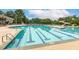 Community pool featuring lap lanes, slide, diving board, seating areas, and lifeguard stand at 100 Emory Bluffs Dr, Holly Springs, NC 27540