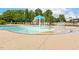 Zero-entry pool and splash pad with fountain features, and multiple seating at 100 Emory Bluffs Dr, Holly Springs, NC 27540