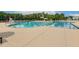 Large community pool with lap lanes, slide, and plenty of seating on a sunny day at 100 Emory Bluffs Dr, Holly Springs, NC 27540