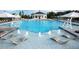 Resort-style swimming pool with lounge chairs, shallow water features, and lush surroundings at 100 Emory Bluffs Dr, Holly Springs, NC 27540