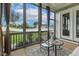 Relaxing screened porch with patio furniture and scenic backyard views at 100 Emory Bluffs Dr, Holly Springs, NC 27540