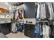 Walk-in closet with custom shelving, drawers, and ample storage space at 100 Emory Bluffs Dr, Holly Springs, NC 27540