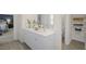 Well-lit bathroom featuring double sinks, a large mirror, and ample storage space at 100 Reagan Crest Dr, Clayton, NC 27520