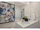 Bathroom featuring a double sink vanity with modern faucets, a large mirror, and stylish decor at 100 Reagan Crest Dr, Clayton, NC 27520