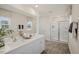 Bathroom with double sinks, a large mirror, and a glass-enclosed shower at 100 Reagan Crest Dr, Clayton, NC 27520