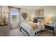 Bright bedroom featuring a neutral color palette, a bed with a decorative headboard, and natural light from a window at 100 Reagan Crest Dr, Clayton, NC 27520