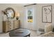 Comfortable bedroom featuring a round mirror, natural light and stylish decor at 100 Reagan Crest Dr, Clayton, NC 27520