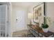 Bright entryway with a front door, an artful wood console table, decor and wood-look flooring at 100 Reagan Crest Dr, Clayton, NC 27520