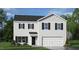 Charming two-story home with black shutters, a gray roof, a two-car garage, and manicured landscaping at 100 Reagan Crest Dr, Clayton, NC 27520