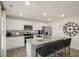 Modern kitchen featuring granite countertops, stainless steel appliances, and bar stool seating at 100 Reagan Crest Dr, Clayton, NC 27520