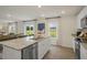 Modern kitchen featuring granite countertops, stainless steel appliances, and an open floor plan at 100 Reagan Crest Dr, Clayton, NC 27520