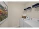 Laundry room with a washing machine, a dryer, shelving, and decor at 100 Reagan Crest Dr, Clayton, NC 27520